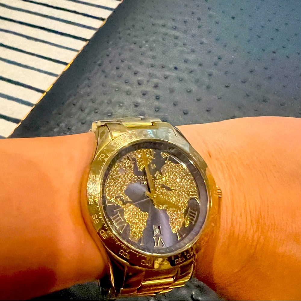 Used Michael Kors gold watch with blue background and map diamonds.